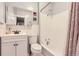 Clean bathroom with white tile, and a shower-tub combo at 4057 Bryant St, Denver, CO 80211