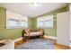 Charming bedroom featuring a cozy crib with natural light and hardwood floors at 4057 Bryant St, Denver, CO 80211