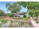 Charming home with a well-manicured front yard featuring beautiful flowers and mature trees at 4057 Bryant St, Denver, CO 80211