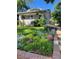 Beautifully landscaped front yard with lush greenery and colorful flowers at 4057 Bryant St, Denver, CO 80211