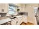 Bright kitchen with white cabinets, quartz countertops, and stainless steel sink at 4057 Bryant St, Denver, CO 80211
