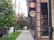 Street view shows trees lining the sidewalk with nearby retail and restaurant buildings at 4057 Bryant St, Denver, CO 80211