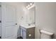 Well-lit half bathroom with white cabinets and silver fixtures and hardware at 8376 Lorenzo Ln # C, Littleton, CO 80129