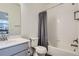 Bathroom featuring a shower/tub combo, and a white vanity with modern hardware at 8376 Lorenzo Ln # C, Littleton, CO 80129