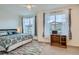 Bright bedroom with large windows, ceiling fan, and a cozy rug at 8376 Lorenzo Ln # C, Littleton, CO 80129