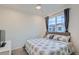 Comfortable bedroom with a large window, ceiling fan, and neutral decor at 8376 Lorenzo Ln # C, Littleton, CO 80129