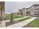 Exterior of new townhomes with stone facades and beautifully maintained landscaping at 8376 Lorenzo Ln # C, Littleton, CO 80129