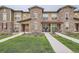 Charming townhome with stone accents, landscaped lawn, and inviting front porch at 8376 Lorenzo Ln # C, Littleton, CO 80129