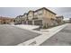 Exterior view of newly-built townhomes, featuring multi-car garages and attractive stone and siding at 8376 Lorenzo Ln # C, Littleton, CO 80129