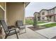 Comfortable porch featuring chairs, a table, and a view of the manicured front lawn and neighboring townhomes at 8376 Lorenzo Ln # C, Littleton, CO 80129