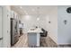 Modern kitchen features stainless appliances, a large island with bar seating, and sleek countertops at 8376 Lorenzo Ln # C, Littleton, CO 80129
