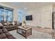 Bright living room with ample seating, a ceiling fan, and large windows at 8376 Lorenzo Ln # C, Littleton, CO 80129