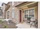 Cozy front porch with seating area, stone accents, and a welcoming entrance at 8376 Lorenzo Ln # C, Littleton, CO 80129