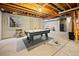 Spacious unfinished basement with a pool table, storage, and exposed ceiling at 10170 E 151St Ct, Brighton, CO 80602