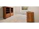 Basement area with wooden cabinets and a window, providing natural light at 10170 E 151St Ct, Brighton, CO 80602