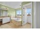 Bright bathroom with a soaking tub and a large window for natural light at 10170 E 151St Ct, Brighton, CO 80602