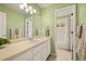 Well-lit bathroom with a single sink vanity, framed mirror, and a separate room with a tub at 10170 E 151St Ct, Brighton, CO 80602