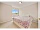 Cozy bedroom featuring plush carpeting, a double bed, and natural light at 10170 E 151St Ct, Brighton, CO 80602