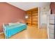Cozy bedroom with wood floors, built-in shelving, and natural light, offering a comfortable retreat at 10170 E 151St Ct, Brighton, CO 80602
