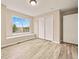 Well-lit bedroom with a window seat and a closet with sliding doors at 10170 E 151St Ct, Brighton, CO 80602