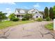 Beautiful two-story home featuring mature trees, a covered porch and manicured landscaping at 10170 E 151St Ct, Brighton, CO 80602