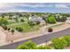 Expansive property featuring a two-story home with a wraparound porch and white fencing at 10170 E 151St Ct, Brighton, CO 80602