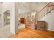 Elegant foyer with hardwood floors, a staircase, and seamless transition to dining and living spaces at 10170 E 151St Ct, Brighton, CO 80602