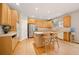 Well-lit kitchen featuring wood cabinets, stainless steel appliances, and a kitchen island with chairs at 10170 E 151St Ct, Brighton, CO 80602