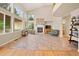 Spacious living room with tile floors, large windows, fireplace, and plenty of natural light at 10170 E 151St Ct, Brighton, CO 80602