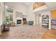 Bright living room features high ceilings, a fireplace, large windows, and plenty of natural light at 10170 E 151St Ct, Brighton, CO 80602