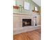 Brick fireplace with wood mantel in the living room at 20954 E Crestline Pl, Centennial, CO 80015