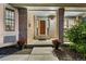 Inviting front porch with brick columns and rocking chairs at 20954 E Crestline Pl, Centennial, CO 80015