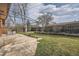 Backyard featuring a lush lawn, mature trees, a patio with outdoor seating, and privacy fencing at 8122 W Woodard Dr, Lakewood, CO 80227