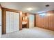 Basement features paneled walls, built-in vanity, and ample closet space at 8122 W Woodard Dr, Lakewood, CO 80227