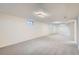 Spacious finished basement with neutral carpet and bright lighting, perfect for entertainment or relaxation at 8122 W Woodard Dr, Lakewood, CO 80227