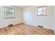 Bright bedroom featuring hardwood floors and dual windows for ample natural light at 8122 W Woodard Dr, Lakewood, CO 80227