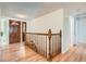 Inviting entryway featuring a wood door, staircase with wood railing, and wood floors at 8122 W Woodard Dr, Lakewood, CO 80227
