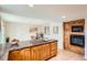 Spacious kitchen with wood cabinets, granite counters, and an adjacent dining area, perfect for Gathering meals at 8122 W Woodard Dr, Lakewood, CO 80227