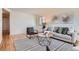 Bright living room with hardwood floors, stylish rug, and comfortable seating arrangement at 8122 W Woodard Dr, Lakewood, CO 80227