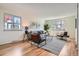 Bright and inviting living room featuring hardwood floors, large windows, and comfortable seating at 8122 W Woodard Dr, Lakewood, CO 80227