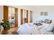 Bright main bedroom featuring mirrored closet doors and a cozy, well-decorated bed at 8122 W Woodard Dr, Lakewood, CO 80227