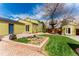 Backyard with patio, garden beds, and playhouse built around a mature tree at 2348 Sherman St, Longmont, CO 80501