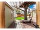 Backyard featuring a treehouse, bench seating, shed, and well-maintained landscaping at 2348 Sherman St, Longmont, CO 80501