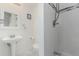 Clean bathroom featuring a pedestal sink, toilet, and a shower with white tiles at 2348 Sherman St, Longmont, CO 80501