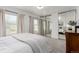 Bright bedroom with mirrored closet doors, two large windows, and plush carpeting at 2348 Sherman St, Longmont, CO 80501