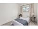 A cozy bedroom featuring a comfortable bed, window with curtains, and two side tables with lamps at 2348 Sherman St, Longmont, CO 80501