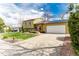 Charming exterior of a two-story home with a well-manicured lawn and attached garage, solar panels, and new concrete driveway at 2348 Sherman St, Longmont, CO 80501