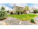 Side view of a two-story home with lawn, landscaping, and detached garage at 2348 Sherman St, Longmont, CO 80501