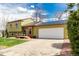 Charming exterior of a two-story home with a well-manicured lawn, solar panels, and attached garage at 2348 Sherman St, Longmont, CO 80501