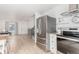 Bright kitchen with stainless steel appliances and an open concept, with stairs to the second level at 2348 Sherman St, Longmont, CO 80501